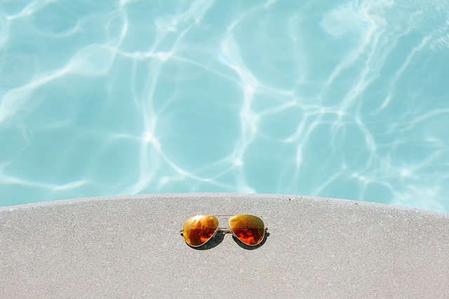 Sunglasses by swimming pool